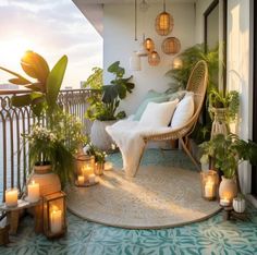 a balcony with potted plants and candles on the floor next to a chair that is sitting on a rug