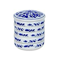 four blue and white plates stacked on top of each other with elephants painted on them