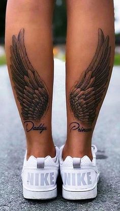 a woman's legs with tattoos and wings on her leg, both showing the word disney