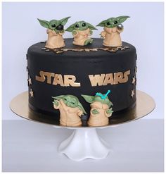 a star wars cake with three baby yoda figures on top