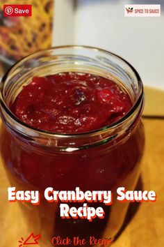 cranberry sauce recipe in a glass jar on a wooden table with text overlay that reads easy cranberry sauce recipe