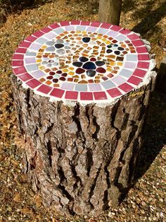 a tree stump with a mosaic design on it