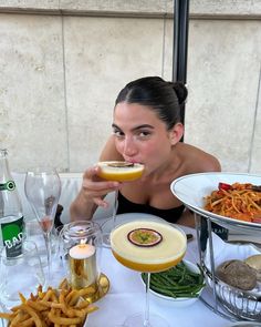 a woman sitting at a table eating food