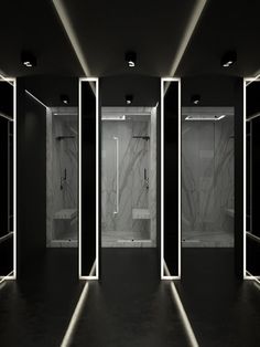 an image of a bathroom setting with mirrors and lights on the walls in black and white