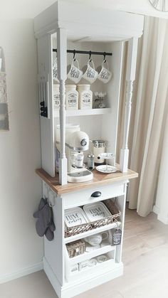 a white shelf with some jars on top of it