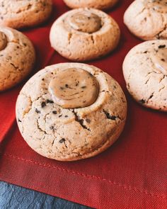 chocolate chip cookies with peanut butter frosting on a red cloth