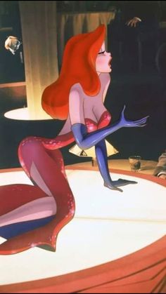 ariel from the little mermaid sitting on top of a table with her legs spread out