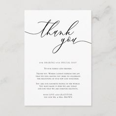 a thank card with the words thank you in black ink on white paper, and an elegant calligraphy font