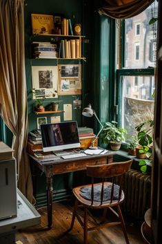 a laptop computer sitting on top of a wooden desk in front of a large window