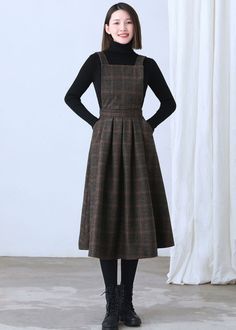 "★★FEATURES * Wool skirt * Polyester lining * Sleeveless * Two side seam pockets * Right hidden zipper closure * Adjustable strap * High waistband * Fit and flare * Perfect for winter, autumn, spring * Dry clean Fabric swatch https://etsy.me/3dIQDkz ★★ The model is 170 cm (5′ 7″) tall with a 80 cm (31.5\") bust, 66 cm (26\") waist. She is wearing the plaid wool dress in size XS. ★★ Bespoke Order Service If you Request other color Request the length Your height is not between 155 cm- 172 cm Your Fall A-line Midi Dress With Pockets, Winter Wool Tweed Dress Knee-length, Knee-length Wool Tweed Dress For Winter, Winter Wool Tweed Knee-length Dress, Fitted Fall Pinafore Dress With Pockets, Winter Midi Dress With Pockets, Fall A-line Dresses With Pockets, Fitted Knee-length Pinafore Dress For Fall, Knee-length Fitted Pinafore Dress For Fall