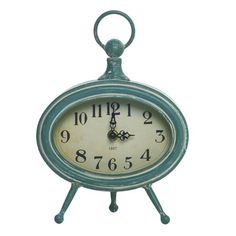 an old fashioned blue clock with numbers on the face and hands, sitting in front of a white background