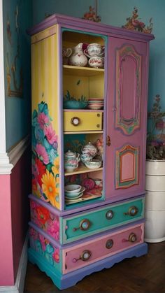 an old china cabinet painted in bright colors