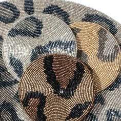 three woven baskets sitting on top of each other in front of a white background with black and brown designs