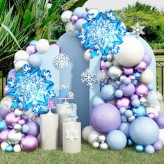 an arch decorated with balloons and snowflakes