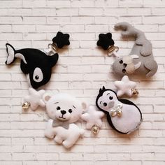 four stuffed animals hanging on a brick wall