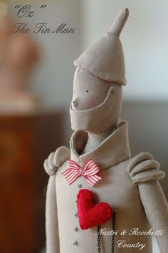 a small doll with a red heart on it's chest