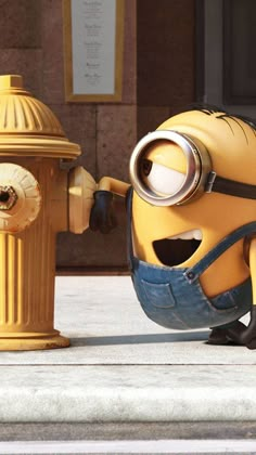 a yellow fire hydrant sitting next to a minion