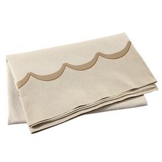 two folded linens on top of each other, one in beige and the other in tan