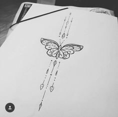 a drawing of a butterfly on top of a piece of paper