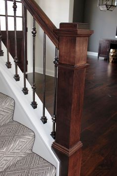 a wooden stair case with metal handrails and wood treading in a house