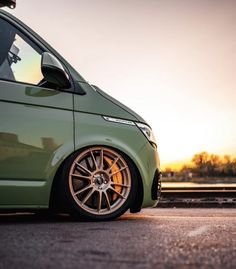 a green van is parked on the street