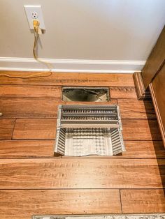 a floor vent in the middle of a wood floor