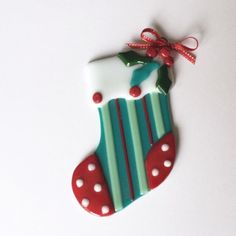 A lovely fused glass holiday stocking ready to adorn your Christmas tree. The stocking is made of teal green glass with white, red and mint accents. The stocking is 3 1/2 inches tall and 2 1/2 wide. Glass Nutcracker, Slumped Glass