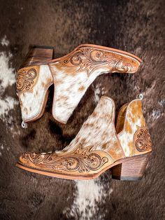 These remarkable boots represent wonderful harmony in design, with hair-on hide and hand-tooled leather coming together. They feature an eye-catching split side design, back pull loops and a tapered heels. A great style experience!  2" slanted heel. 6-11 not available in half sizes. THESE RUN LARGE. SIZE DOWN A SIZE FR Cowboy Heels, Harmony In Design, Cowgirl Closet, Closet Clothes, Hay Bag, Western Shoes, Wrap Boots, Silver Jewelry Box, Horse Accessories