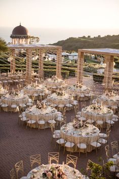 an outdoor wedding setup with tables and chairs