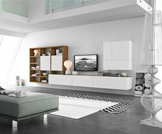 a modern living room with white furniture and black and white rugs on the floor