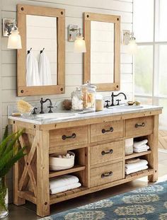 a bathroom vanity with two mirrors above it and towels on the counter top next to it