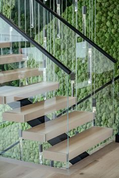 the stairs are made of glass and wood