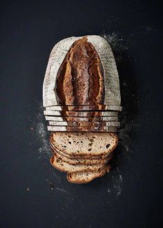 a loaf of bread sitting on top of a black surface