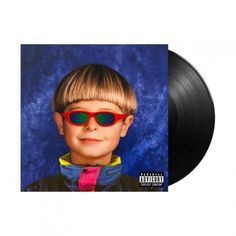 a black vinyl album cover with a young boy wearing red sunglasses and a blue background