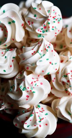 a bowl filled with white frosting and sprinkles