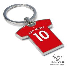 a metal keychain with a soccer jersey on it's front and back sides