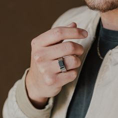 a man wearing a ring that is on his finger