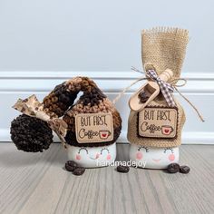 two salt and pepper shakers decorated with burlocked coffee beans are sitting next to each other