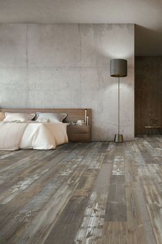 a bedroom with wood flooring and white walls