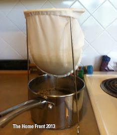 a stove top with a pot on it and a towel hanging over the burner