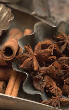 cinnamon sticks and star anise in a metal bowl