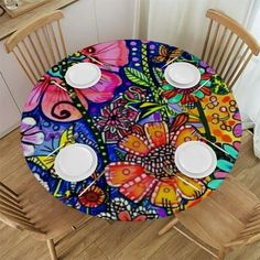 the table is covered with colorful flowers and butterflies