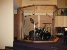 a drum kit is in a glass case