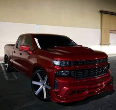 a red truck parked in a parking lot