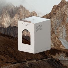 an open box on top of a mountain with mountains in the background