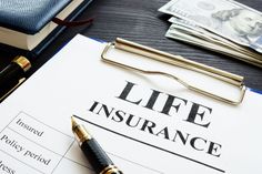 a life insurance form with pen and money