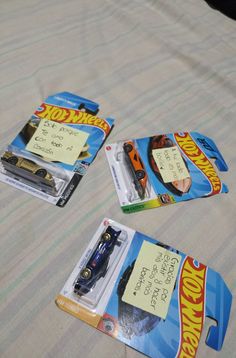 three hot wheels cards are laying on the bed with their price tags attached to them