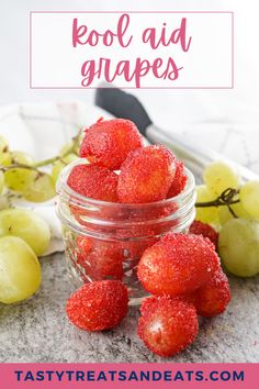 some strawberries are in a glass jar with the words cool aid grapes