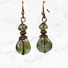 Lovely teardrop woodland green Czech glass teardrop and shell shaped beads. These minimalist earrings have a beautiful luster with a light golden wash. Exceptional beads. Everyday jewelry, short earrings. Copper finish beads, bead caps.  Can be worn casually or for dress up. Really beautiful beads with just the right amount of shimmer. Longer version: https://www.etsy.com/listing/1349678467/green-woodland-long-earrings-green Also available in PURPLE here: https://www.etsy.com/listing/1381407117/purple-teardrop-earrings-boho-earrings Artisan glass beads produced in small quantities in Czech Republic  Hypoallergenic ear wires (nickel and lead free). Choose ear wire style at checkout. A gift for you or someone special, earrings are carded and in an organza bag. Link back to my shop: https://w Short Earrings, Woodland Earrings, Bead Dangle Earrings, Earthy Jewelry, Glass Bead Earrings, Earthy Green, Piercings Jewelry, Teardrop Beads, Funky Jewelry