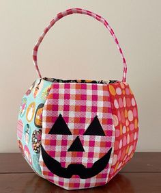 a trick or treat bag with a pumpkin face on it